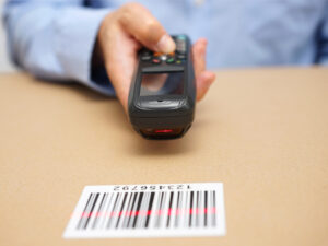 warehouse technician inspects stocks in storage with bar code reader