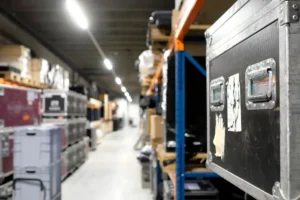 Event rental warehouse with organized road cases and equipment storage supporting pull sheets, warehouse prep, AV inventory management, and event production logistics.