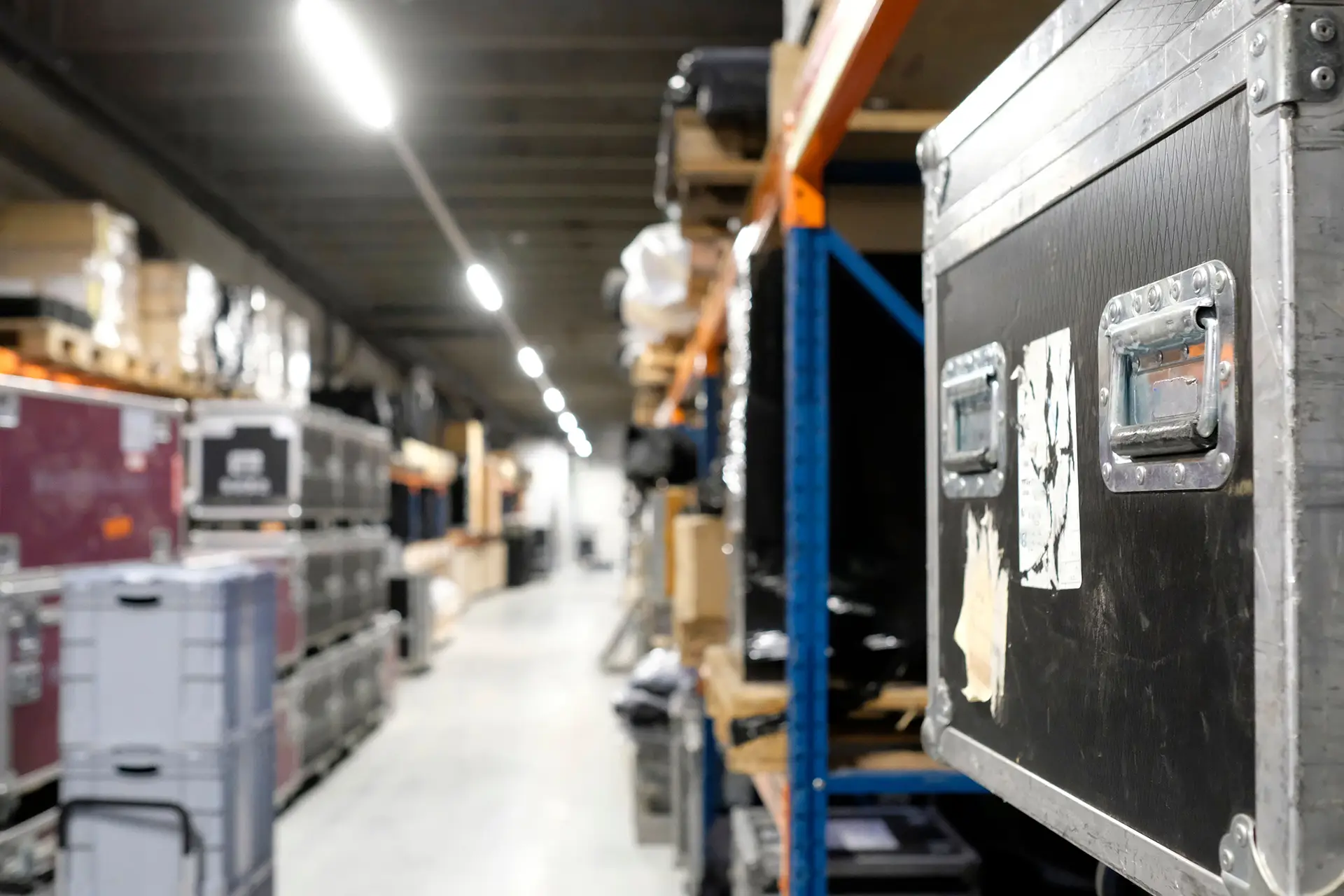 Event rental warehouse with organized road cases and equipment storage supporting pull sheets, warehouse prep, AV inventory management, and event production logistics.